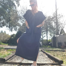 Load image into Gallery viewer, A classic oversized tunic dress for the everyday. This is a Maxi/Ankle length version of one of our bestselling dresses, the BANDED FREEDOM DRESS. Featuring a scoop neckline with an extended shoulder with loose fitting sleeve bands + patch pockets, along with the addition of double side slits on this longer version for complete ease of movement + comfortability. Designed for the days spent lounging around the house, playing in the garden, reading a good book + working in your home office, this dress is so v
