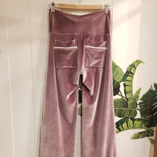 Load image into Gallery viewer, A darling pajama pant for everyday. Made in a luxurious stretch velvet, this pant features a medium to high rise fit with a wide waistband, back patch pockets + side pom pom detailing that runs down the side of this cropped length relaxed leg. Perfectly chic for lounging day or night!
