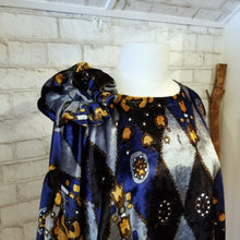 Load image into Gallery viewer, All the romantic vintage feels in this one of a kind avante garde top. Featuring a scoop neckline, long balloon sleeves, a loose flowy hemline and a large rosette on the shoulder. Handcrafted in a blue and golden tone vintage diamond + floral printed velvet, we promise you will truly enjoy slipping on this beauty the very first chance you get!
