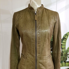 Load image into Gallery viewer, A complete labor of LOVE! This olive green vintage Canadian Brand DANIER leather jacket has been upcycled with a whole lot of love, literally. The sleeve cuffs have been enhanced with a whole bunch of small appliqued leather hearts, twelve to be exact, so unique, and so incredibly One-of-a-Kind. Scoop up this beauty and feel loved everyday!
