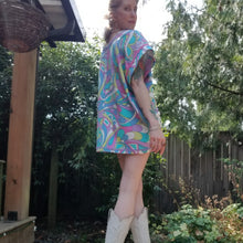 Load image into Gallery viewer, An oversized super micro length tunic dress handcrafted using a retro PUCCI inspired cotton. Featuring a scoop neckline with an extended shoulder with loose fitting sleeve bands, both featuring vintage embroidered lace trims + patch pockets framed with a pink lace, a heart shaped applique and an ultra pretty satin bow in the center. Completely unordinary, and perfectly chic retro meets modern cowgirl with your fav pair of boots!
