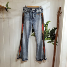 Load image into Gallery viewer, Your wardrobe will thank you and your booty will love you with these 70&#39;s inspired UPCYCLED Driftwood Jeans. Featuring embroidered suede patchwork tuxedo side panels accented with gold studs, also found on the back pockets, and 3 hand embroidered script&#39;s including our signature &#39;LOVED&#39; and &#39;ROCK STAR&#39; found on the bottom bsck legs, because we all have an inner rock star and we should all feel loved, everyday!&nbsp;
