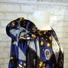 Load image into Gallery viewer, All the romantic vintage feels in this one of a kind avante garde top. Featuring a scoop neckline, long balloon sleeves, a loose flowy hemline and a large rosette on the shoulder. Handcrafted in a blue and golden tone vintage diamond + floral printed velvet, we promise you will truly enjoy slipping on this beauty the very first chance you get!
