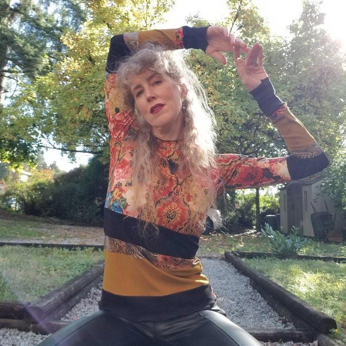 Unique on it's own or layer up this beauty! A one of a kind classic fitted mock neck top featuring x-long sleeves, handcrafted in a mixed patchwork of earth tones, art deco florals, liquid waves and 2-tone organic ribbed knits. Slip this beauty on and set your mark for the day!