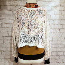 Load image into Gallery viewer, A sweet romantic top for everyday. Featuring a scoop neckline, long balloon sleeves and a loose flowy waist length hemline. Wear freely on it&#39;s own or layer with any of our tops for a unique vintage feeling topper look. Handcrafted in a luscious cream colored corded floral lace, so perfect for day to night in complete romantic style!
