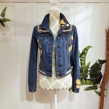 Load image into Gallery viewer, A complete labor of LOVE! This ONE OF A KIND upcycled denim jean jacket features hand appliqued tri-colored earth tone leather flowers throughout the entire jacket along with a &#39;Mayan Temple&#39; inspired design theme on the focal back feature. The unique vintage small crochet trim and center back exquisitely embroidered motif is a delight to the eye having an architectural feel strengthened by the 10mm gold pyramid studs. You will also find our signature hand-embroidered &quot;LOVED&quot; script on the right sleeve.
