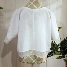 Load image into Gallery viewer, A sweet minimalist free flow linen top for everyday! Featuring a classic V-neck, this free sized top is detailed with beautiful cotton crochet lace along the top shoulders, sleeves and hemline, creating a perfectly chic + effortless look you can pair with everything in your wardrobe. Slip on this beauty and feel the love!
