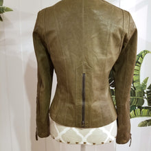 Load image into Gallery viewer, A complete labor of LOVE! This olive green vintage Canadian Brand DANIER leather jacket has been upcycled with a whole lot of love, literally. The sleeve cuffs have been enhanced with a whole bunch of small appliqued leather hearts, twelve to be exact, so unique, and so incredibly One-of-a-Kind. Scoop up this beauty and feel loved everyday!
