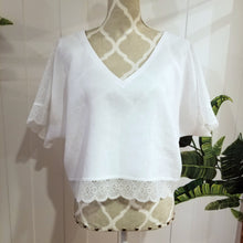 Load image into Gallery viewer, A sweet minimalist free flow linen top for everyday! Featuring a classic V-neck, this free sized top is detailed with beautiful cotton crochet lace along the top shoulders, sleeves and hemline, creating a perfectly chic + effortless look you can pair with everything in your wardrobe. Slip on this beauty and feel the love!
