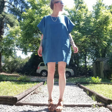 Load image into Gallery viewer, A classic oversized tunic dress for the everyday. This is a 2&quot; shorter version than our regular Banded Freedom Dress. Featuring a scoop neckline with an extended shoulder with loose fitting sleeve bands + patch pockets. Designed for the days spent lounging around the house, playing in the garden, reading a good book + working in your home office, this dress is so versatile. Feel the comfort in this style + the freedom to do it!
