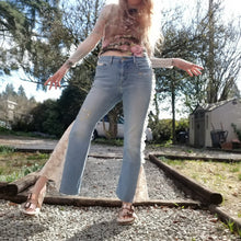 Load image into Gallery viewer, A completely upcycled LEVI denim crop flare jean featuring the sweetest country daisy cotton crochet lace with scalloping along the edges set in a unique asymmetrical detailing, gold + silver hand appliqued studded heart motifs, a one sided cotton eyelet trimmed side seam and 2 of our hand-embroidered LOVED scripts in soft pastel tones of gold, ivory and pink. Scoop up these beauties and feel loved everyday!
