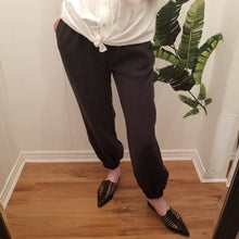 Load image into Gallery viewer, A classic easy fit pant for the everyday. Featuring elasticized waist + ankles as well as pockets in the side seams. Designed for the days spent lounging around the house, playing in the garden, reading a good book + working in your home office, these pants are so versatile. Feel the comfort in this style + the freedom to do it!
