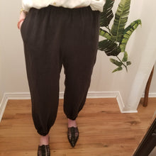 Load image into Gallery viewer, A classic easy fit pant for the everyday. Featuring elasticized waist + ankles as well as pockets in the side seams. Designed for the days spent lounging around the house, playing in the garden, reading a good book + working in your home office, these pants are so versatile. Feel the comfort in this style + the freedom to do it!
