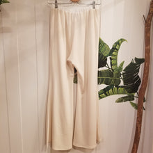 Load image into Gallery viewer, A classic high waist relaxed flare pant for the everyday. Featuring an elasticized waist with drawstring and pockets. Designed for everything from lounging, playing + working whether it&#39;s in your home office or on the go, these pants are so versatile and ultra comfy cozy you won&#39;t want to take them off!
