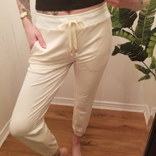 Load image into Gallery viewer, A classic medium rise tapered leg pant for the everyday. Featuring a wide stretch rib knit waistband with a drawstring and front and back pockets. Designed for everything from lounging, playing + working whether it&#39;s in your home office or on the go, these pants are so versatile and ultra comfy cozy you won&#39;t want to take them off!
