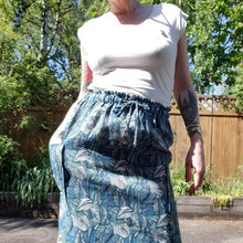 Load image into Gallery viewer, A classic super relaxed fit skirt for the everyday. Featuring an elasticized waist with a drawstring, patch pockets and double side slits at hem. Designed for the days spent lounging around the house, playing in the garden, reading a good book + working in your home office, this skirt is so versatile. Feel the comfort in this style + the freedom to do it!
