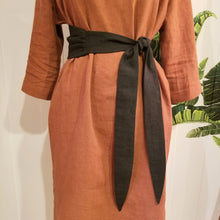 Load image into Gallery viewer, This is a perfectly simple long classic linen belt featuring a wider ruched center panel and 2 narrow pointed belt ends that you can tie multiple ways. This belt is the perfect addition to wrap around any of our linen styles or you can wrap it, knot it, bow it, or tie it any way you like around any of your shirts, blouses, lightweight sweaters, tops or dresses. Create a slimming silhouette today with this great piece!
