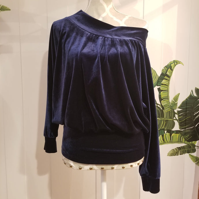 Slip on this ever so luscious + cozy stretch velvet sweater top, featuring a wide boat neckline that makes this a chic shoulder baring piece, perfect on it's own or as a staple layering piece. Long sleeves for added warmth and an extra wide hemband that keeps you warm all the way down to the hips. Wear this beauty on or off the shoulder while you lounge + relax in comfort or for a special night out, especially paired with our luscious stretch velvet bottoms it's the ever so chic style set for the fall/winte