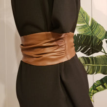 Load image into Gallery viewer, This lovely plush back vegan leather belt features a clean raw finished edge that features gathering at the side seams and 2 pointed tail ends. A great wardrobe staple as you can take this belt style and wrap it, knot it, bow it, tie it any way you like around any of your shirts, blouses, lightweight sweaters, tops or dresses. Create a slimming silhouette today with this great piece!
