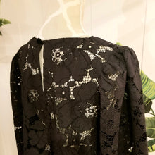 Load image into Gallery viewer, This sweet A-line styled swing top is the perfect piece for any special event! Handcrafted in this luscious black floral lace, it features long bell sleeves with a stunning large scalloped edge finish and a loose swing style body with a semi hi lo scooped hemline. Perfectly easy to slip on and off with the button closure at the back neck, all you need is perhaps a pair of our velvet Luxe Lounge or Flare Pants or one of our skirts for the bottom and your ready to go!
