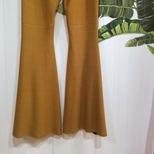 Load image into Gallery viewer, Absolute chic style in these must have flares! Featuring a high rise fitted waistband, this slimming leg pant features a contrasting side stripe with golden pyramid spikes will give you a real sexy and empowering feel. Fitted to the knees and flowing out into a super flared hem, just slip on these classics and have fun mixing + matching them with all of our other knit styles as well as everything else in your wardrobe!
