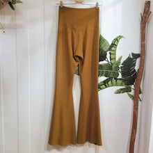 Load image into Gallery viewer, Absolute chic style in these must have flares! Featuring a high rise fitted waistband, this slimming leg pant features a contrasting side stripe with golden pyramid spikes will give you a real sexy and empowering feel. Fitted to the knees and flowing out into a super flared hem, just slip on these classics and have fun mixing + matching them with all of our other knit styles as well as everything else in your wardrobe!
