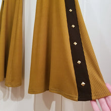 Load image into Gallery viewer, Absolute chic style in these must have flares! Featuring a high rise fitted waistband, this slimming leg pant features a contrasting side stripe with golden pyramid spikes will give you a real sexy and empowering feel. Fitted to the knees and flowing out into a super flared hem, just slip on these classics and have fun mixing + matching them with all of our other knit styles as well as everything else in your wardrobe!
