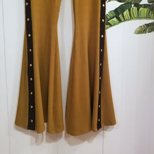 Load image into Gallery viewer, Absolute chic style in these must have flares! Featuring a high rise fitted waistband, this slimming leg pant features a contrasting side stripe with golden pyramid spikes will give you a real sexy and empowering feel. Fitted to the knees and flowing out into a super flared hem, just slip on these classics and have fun mixing + matching them with all of our other knit styles as well as everything else in your wardrobe!
