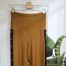 Load image into Gallery viewer, Absolute chic style in these must have flares! Featuring a high rise fitted waistband, this slimming leg pant features a contrasting side stripe with golden pyramid spikes will give you a real sexy and empowering feel. Fitted to the knees and flowing out into a super flared hem, just slip on these classics and have fun mixing + matching them with all of our other knit styles as well as everything else in your wardrobe!
