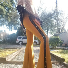 Load image into Gallery viewer, Absolute chic style in these must have flares! Featuring a high rise fitted waistband, this slimming leg pant features a contrasting side stripe with golden pyramid spikes will give you a real sexy and empowering feel. Fitted to the knees and flowing out into a super flared hem, just slip on these classics and have fun mixing + matching them with all of our other knit styles as well as everything else in your wardrobe!
