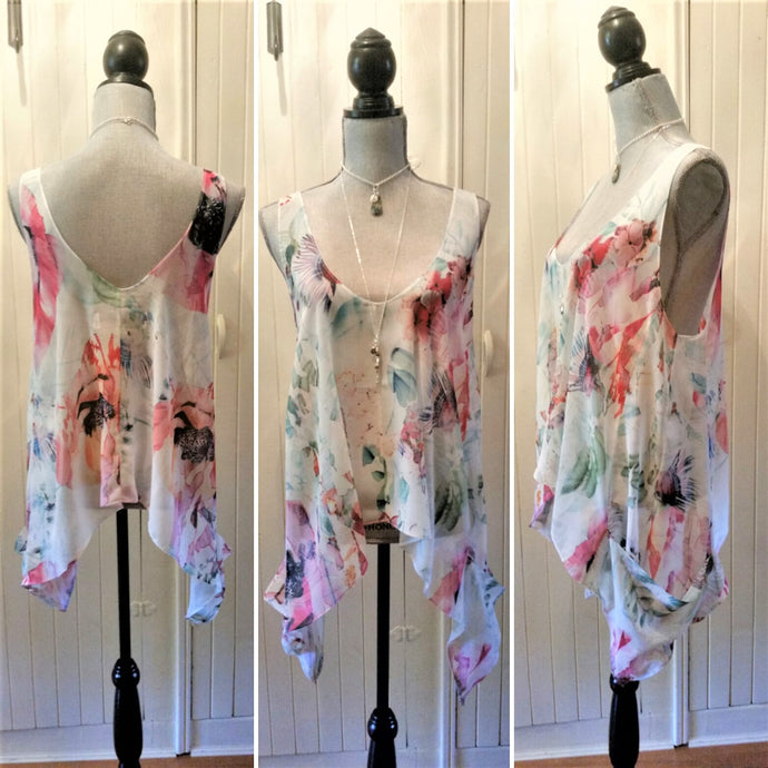 A summertime everyday staple! A beautiful layering top with a V-neckline front and back, dropped underarms and long exaggerated angled side seams with billowy pockets make this loose, oversized, flowy tank the perfect cool piece. Just layer it with your favorite bandeaux, lace bralette, camisole or over a swimsuit and your ready to go!