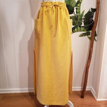 Load image into Gallery viewer, A classic super relaxed fit skirt for the everyday. Featuring an elasticized waist with a drawstring, patch pockets and double side slits at hem. Designed for the days spent lounging around the house, playing in the garden, reading a good book + working in your home office, this skirt is so versatile. Feel the comfort in this style + the freedom to do it!
