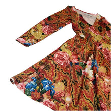 Load image into Gallery viewer, A classic swing dress for everyday! Made in a rich red and gold tone rose print silky knit and featuring a V-neck front, fitted waist and a semi full skirt. It had side pockets and fitted sleeves featuring heart shaped elbow patches in a pearlized pink leather.
